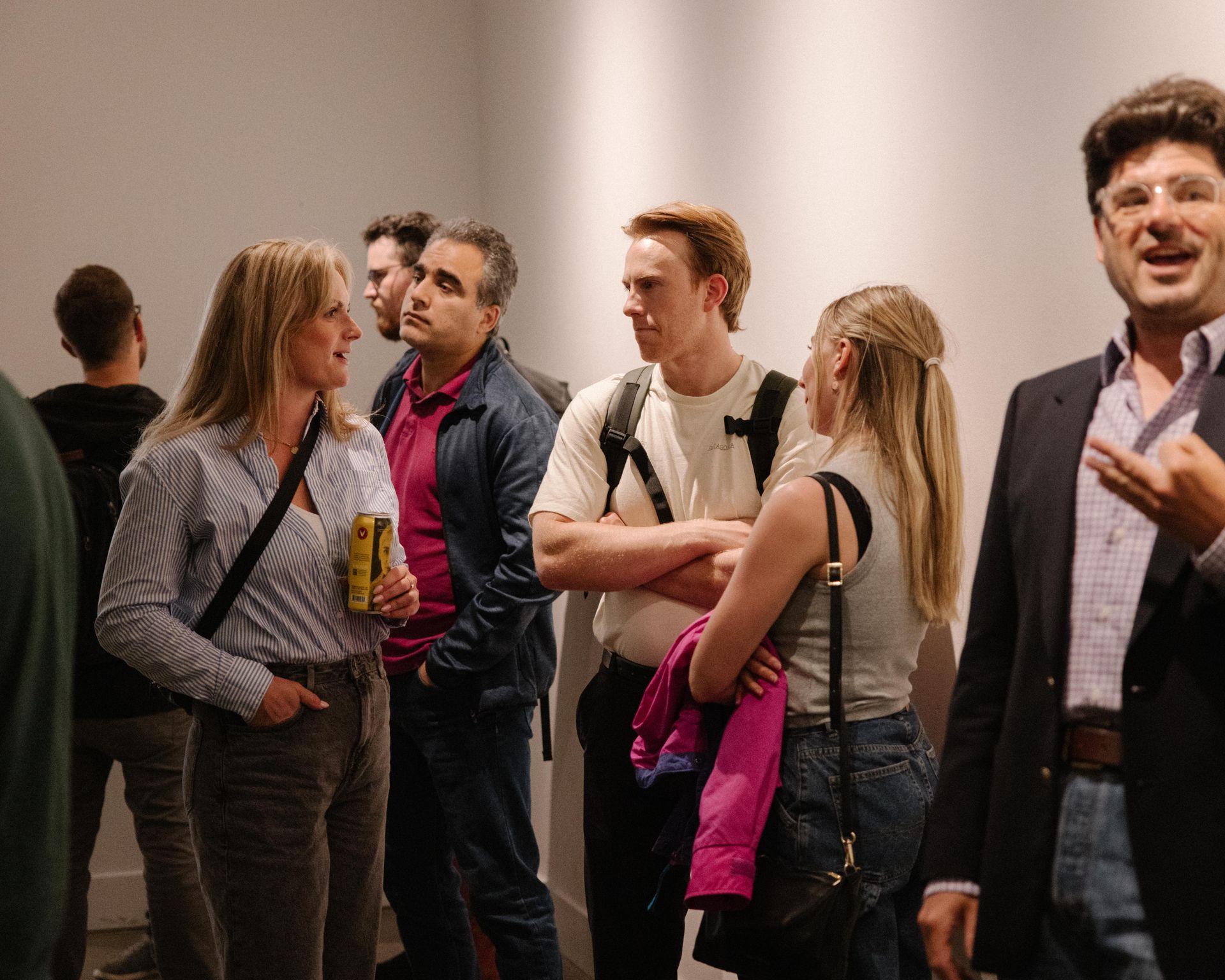 Group of people casually talking and socializing at a Tech Thursday panel in Calgary. 